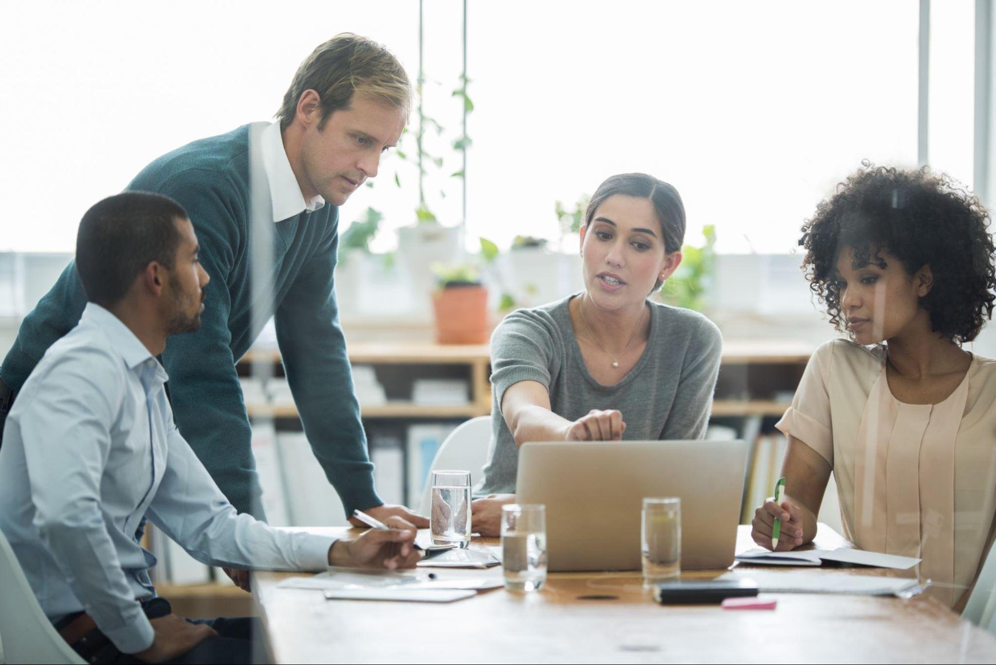 a group of professionals working at a conference table together